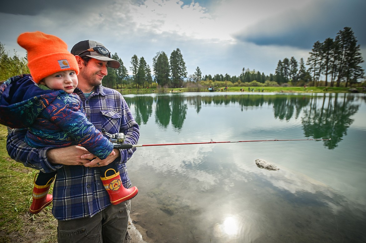 Sal Baccaro fishes with his son Trail at the Brooke Hanson Memorial Family Fishing Day at Pine Grove Pond on Saturday, May 21. Hundreds of prizes were donated by area merchants and sportsmen's groups to be awarded to kids 12 and under. The event was sponsored by Flathead Wildlife and donations go to enhancing fishing opportunities around the Flathead in Brooke Hanson's memory. (Casey Kreider/Daily Inter Lake)