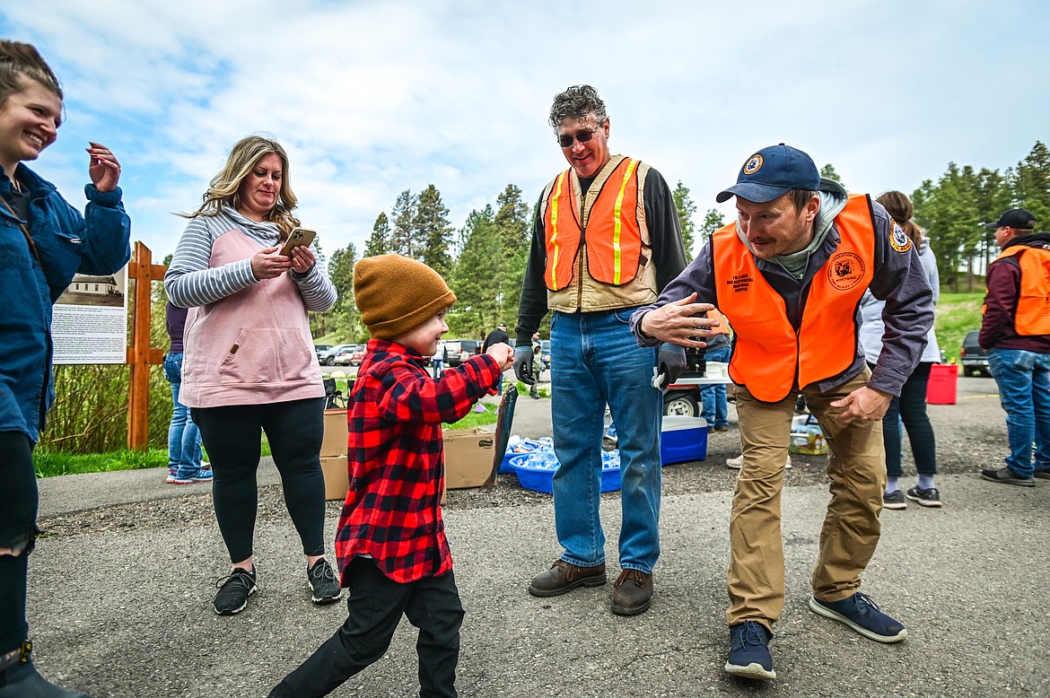 Blu Meehan holds the first fish he has ever caught as he walks to ring the Pine Grove School bell at the Brooke Hanson Memorial Family Fishing Day at Pine Grove Pond on Saturday, May 21. Hundreds of prizes were donated by area merchants and sportsmen's groups to be awarded to kids 12 and under. The event was sponsored by Flathead Wildlife and donations go to enhancing fishing opportunities around the Flathead in Brooke Hanson's memory. (Casey Kreider/Daily Inter Lake)