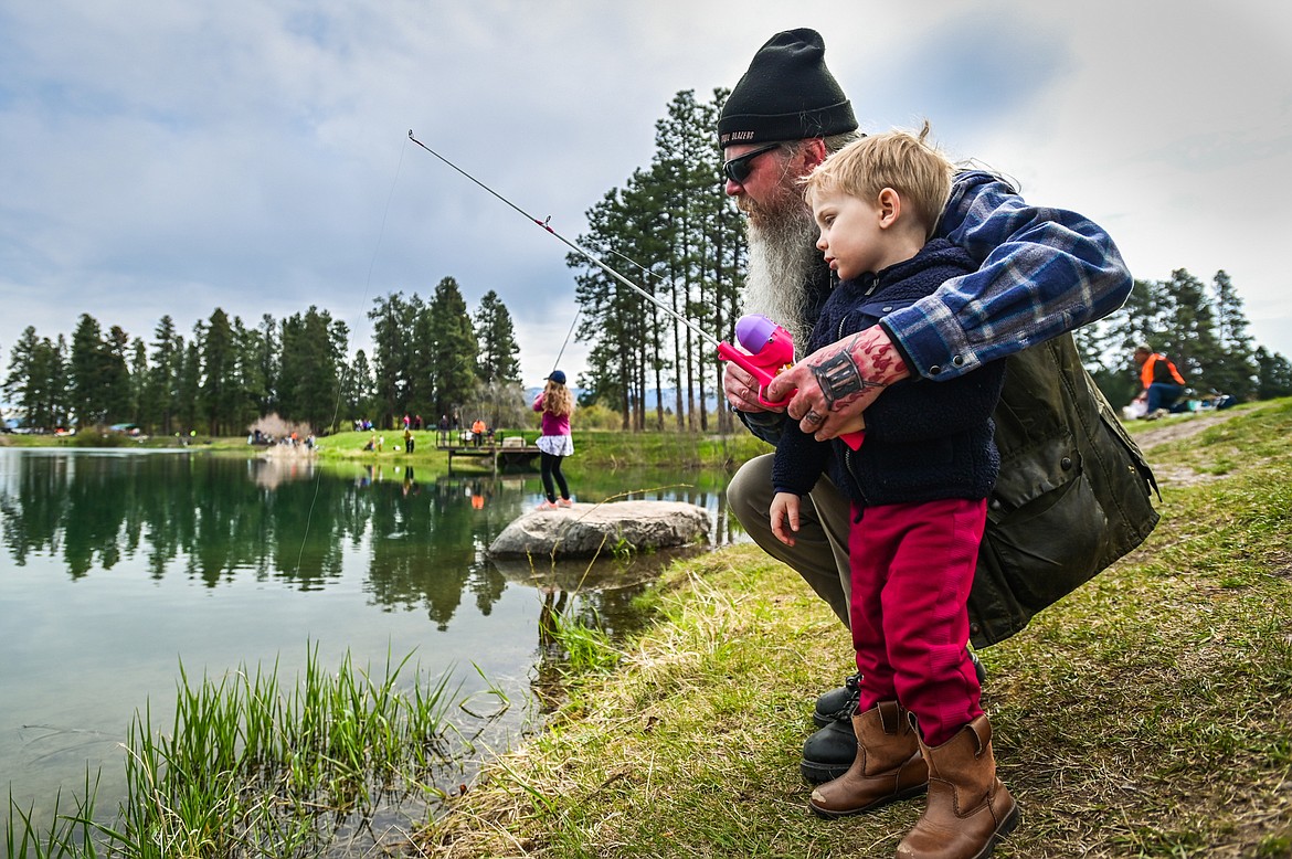 Rich Crouch fishes with his grandson Waylon at the Brooke Hanson Memorial Family Fishing Day at Pine Grove Pond on Saturday, May 21. Hundreds of prizes were donated by area merchants and sportsmen's groups to be awarded to kids 12 and under. The event was sponsored by Flathead Wildlife and donations go to enhancing fishing opportunities around the Flathead in Brooke Hanson's memory. (Casey Kreider/Daily Inter Lake)