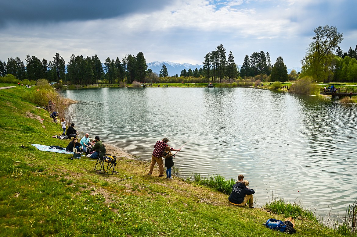 Families fish along the shoreline of Pine Grove Pond at the Brooke Hanson Memorial Family Fishing Day on Saturday, May 21. Hundreds of prizes were donated by area merchants and sportsmen's groups to be awarded to kids 12 and under. The event was sponsored by Flathead Wildlife and donations go to enhancing fishing opportunities around the Flathead in Brooke Hanson's memory. (Casey Kreider/Daily Inter Lake)