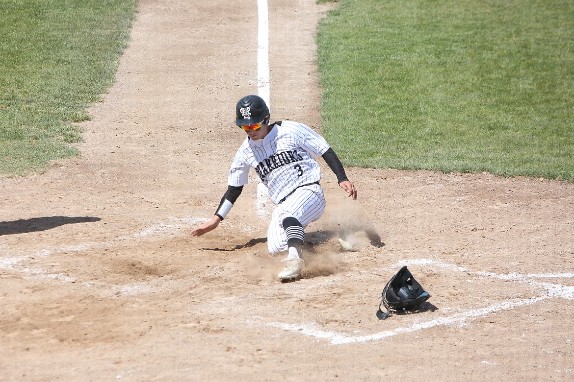 Almira/Coulee-Hartline’s Cody Kagele slides into home base in the fourth inning of the Warrior’s 5-2 win over Mount Vernon Christian on May 21, 2022.