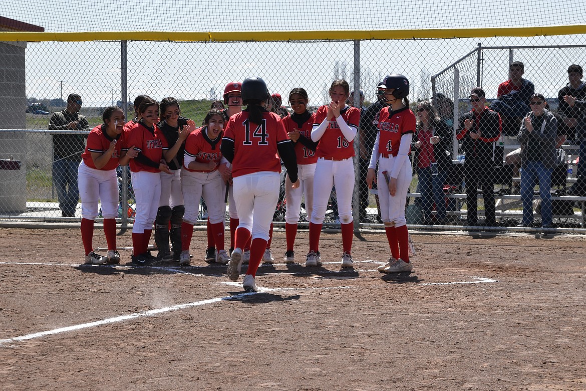 Othello High School players cheer their teammate on as she makes it to home base in the game against Moses Lake High School on April 23. Othello took the District 5/6 2A title and will play at the state tournament this weekend.