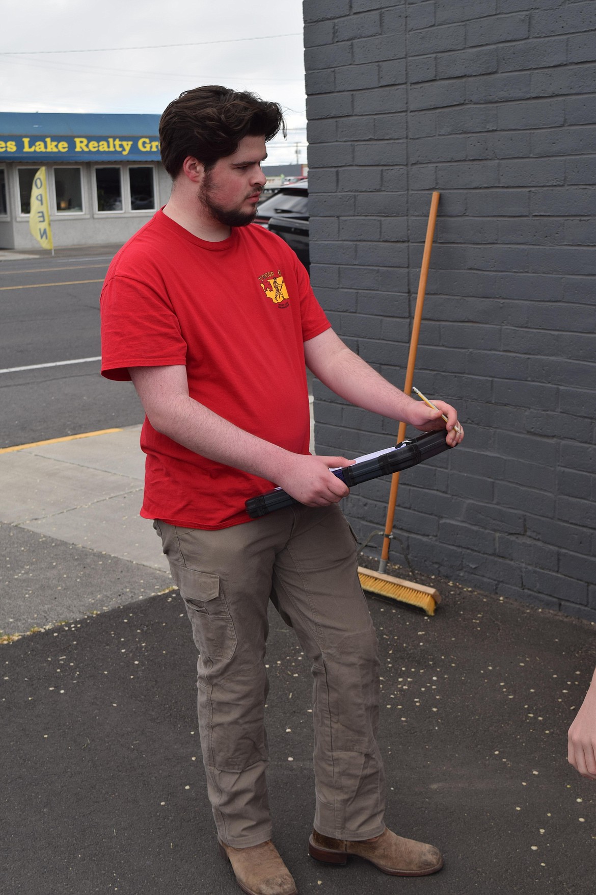 Eagle Scout Garrett Smith watches as the flag box is installed. The box is Smith’s Eagle Scout project and he said he’s learned a lot about serving his community from the project.