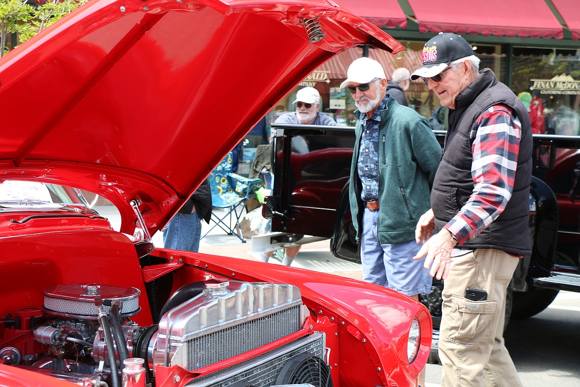 A pair check out one of the hundreds of classic and vintage cars at the Lost in the '50s show in downtown Sandpoint after it returned for its 35th anniversary following a two-year hiatus due to the pandemic.