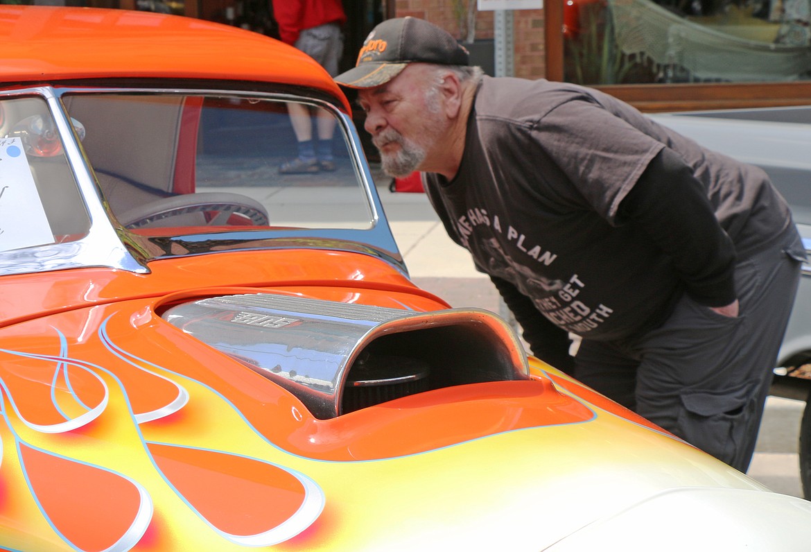A man checks out one of the hundreds of classic and vintage cars at the Lost in the '50s show in downtown Sandpoint after it returned for its 35th anniversary following a two-year hiatus due to the pandemic.