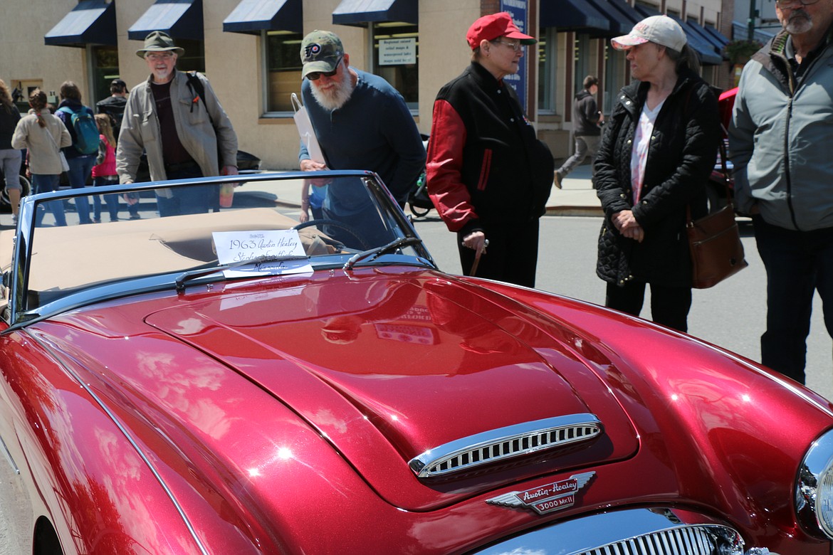 A few classic car fans check out a 1963 Austin Healey at the Lost in the '50s car show in Sandpoint.