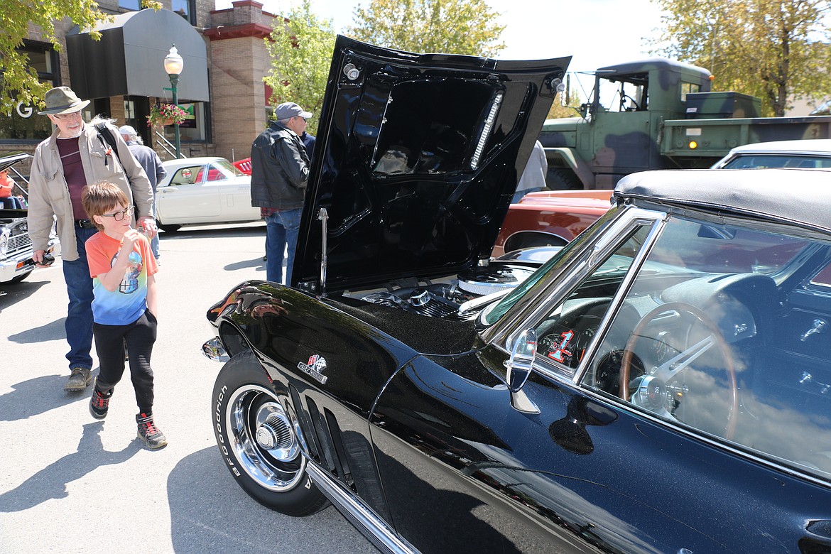 Lost in the '50s car show fans look over a 1966 Corvette owned by Charles Mooney of Silverton as the homage to all things '50s and '60s made its return to the streets of downtown Sandpoint on Saturday.