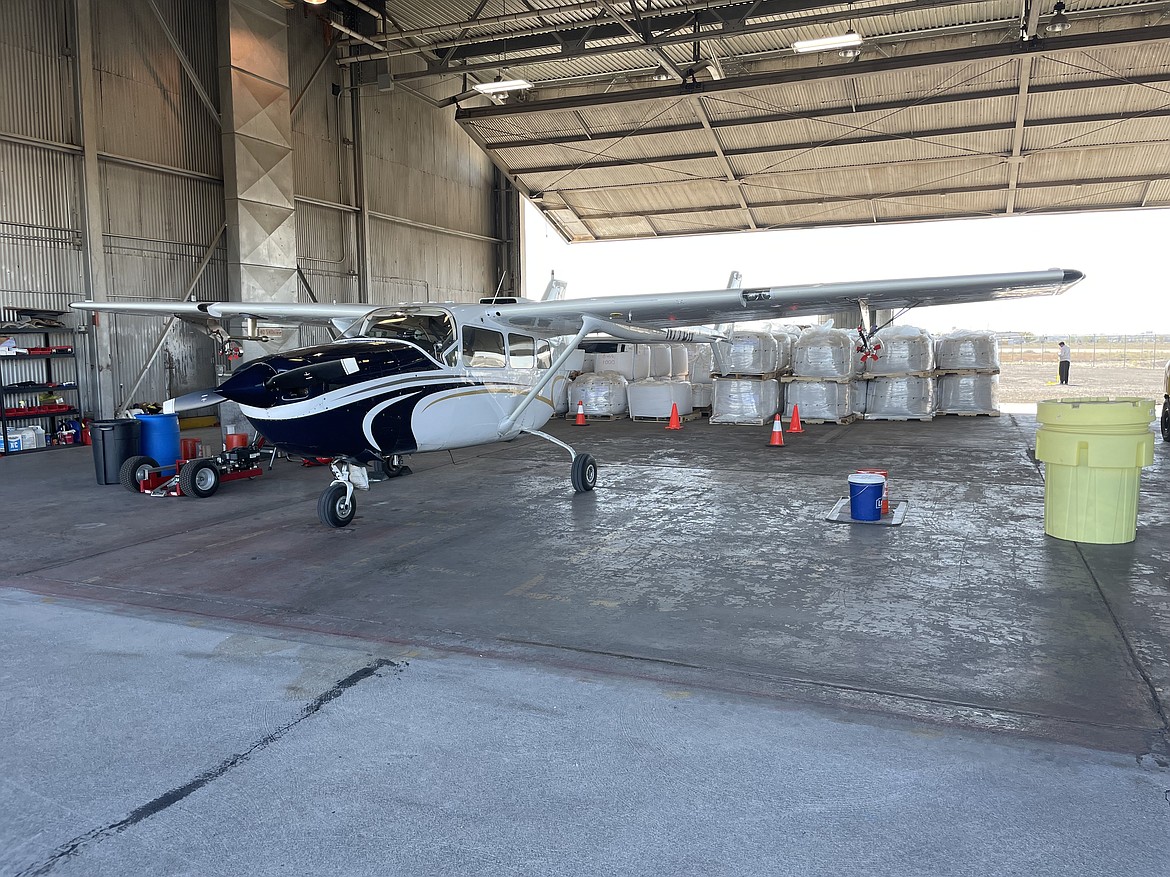 Grant County Mosquito Control District 1’s twin-engine Cessna Skymaster 337 (the second engine is in the back) modified to spray mosquitocide sits in a rented hangar at the Grant County International Airport in front of 1,000-pound bags of insecticide. Despite being based at the Moses Lake Municipal Airport, the district uses the longer runway at GCIA to take off and land because it’s safer for its heavily-laden sprayer aircraft, according to District Manager Ann Belchik-Moser.