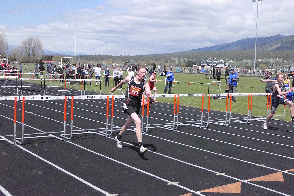 Plains hurdler Mason Elliot clears one of the last hurdles during the Class B Divisional meet this past weekend in Frenchtown.  (Chuck Bandel/VP-MI)