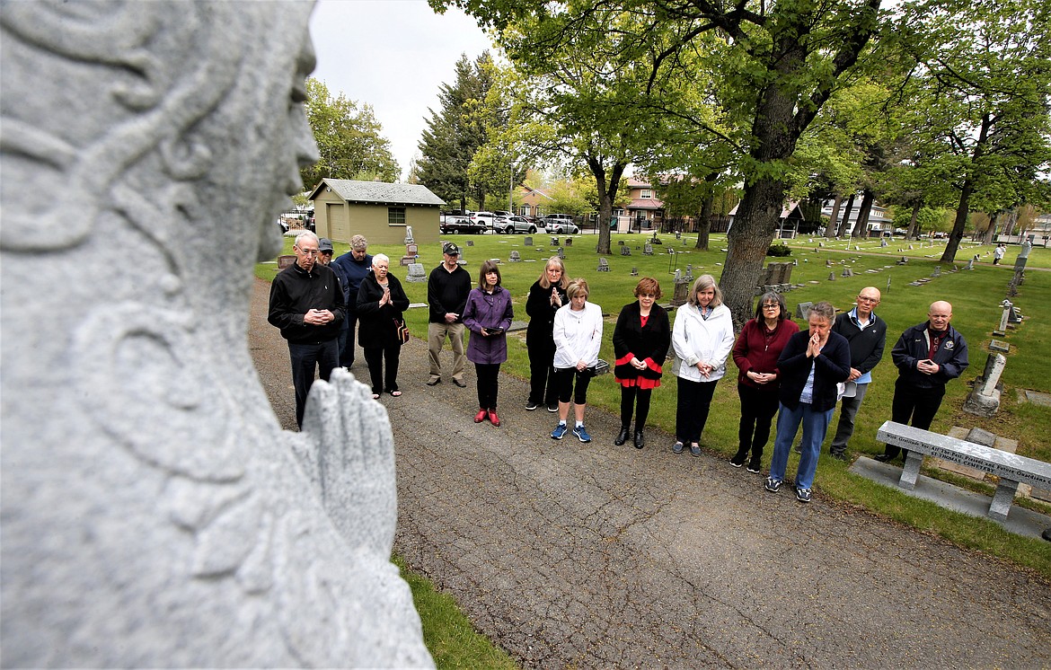 A blessing ceremony is held at St. Thomas Cemetery on Monday.