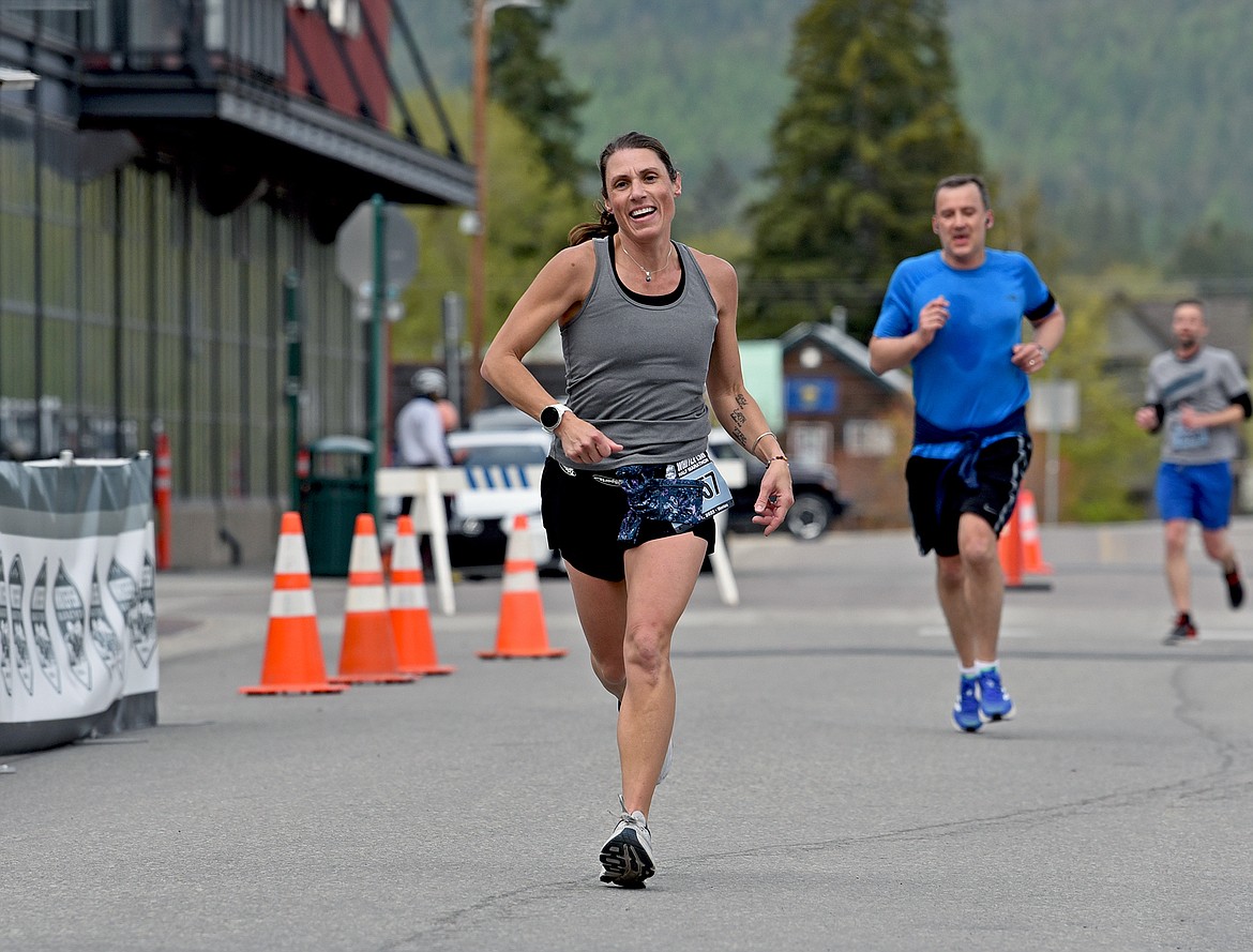 Sarah Peterson of Whitefish runs through the finish line at the Whitefish Marathon. She participated in the half marathon race and completed it in a time of 1:53:33. The 2022 Whitefish Marathon had a chilly 8 a.m. start and the cool temps made for great running conditions for the over 800 finishers across the full marathon, half marathon and 5K. (Whitney England/Whitefish Pilot)