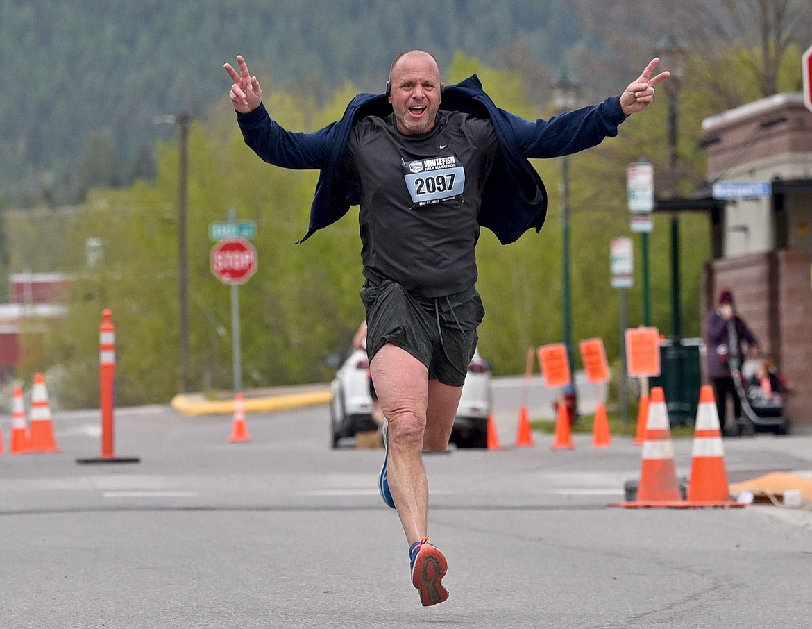 Chris Adamcyk of Kalispell crosses the finish line of the Whitefish Half Marathon on Saturday. (Whitney England/Whitefish Pilot)