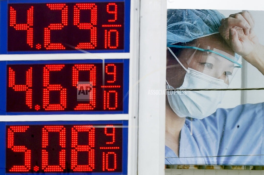 High gas prices are seen in front of a medical billboard on May 11, 2022, in Milwaukee. Americans are becoming less supportive of punishing Russia for launching its invasion of Ukraine if it comes at the expense of the U.S. economy, a sign of rising anxiety over inflation and other challenges. That's according to a new poll from The Associated Press-NORC Center for Public Affairs Research. (AP Photo/Morry Gash, File)