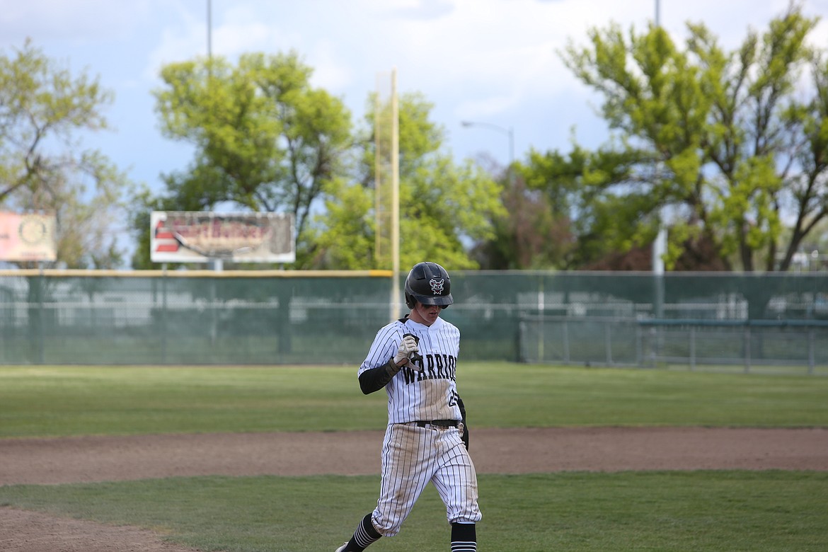 Almira/Coulee-Hartline’s Cooper Correia, covered in dirt, runs to third base after sliding into second in the Warrior’s 5-2 win over Mount Vernon Christian on May 21, 2022.