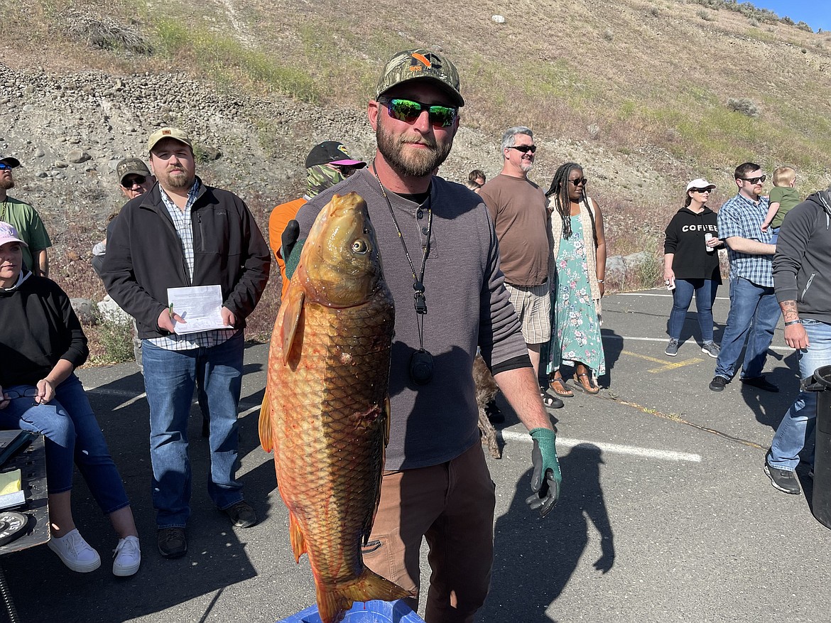 Dallas Wells, a bowfisher from Vancouver, Washington holds up a carp he shot in Moses Lake on Saturday during the Moses Lake Carp Classic. Wells, who has been bowfishing carp for the last six years, said this year’s carp classic was his first tournament. The carp classic was organized to help clear out some of Moses Lake’s carp and improve water quality. For more details, check out the Wednesday edition of the Columbia Basin Herald.