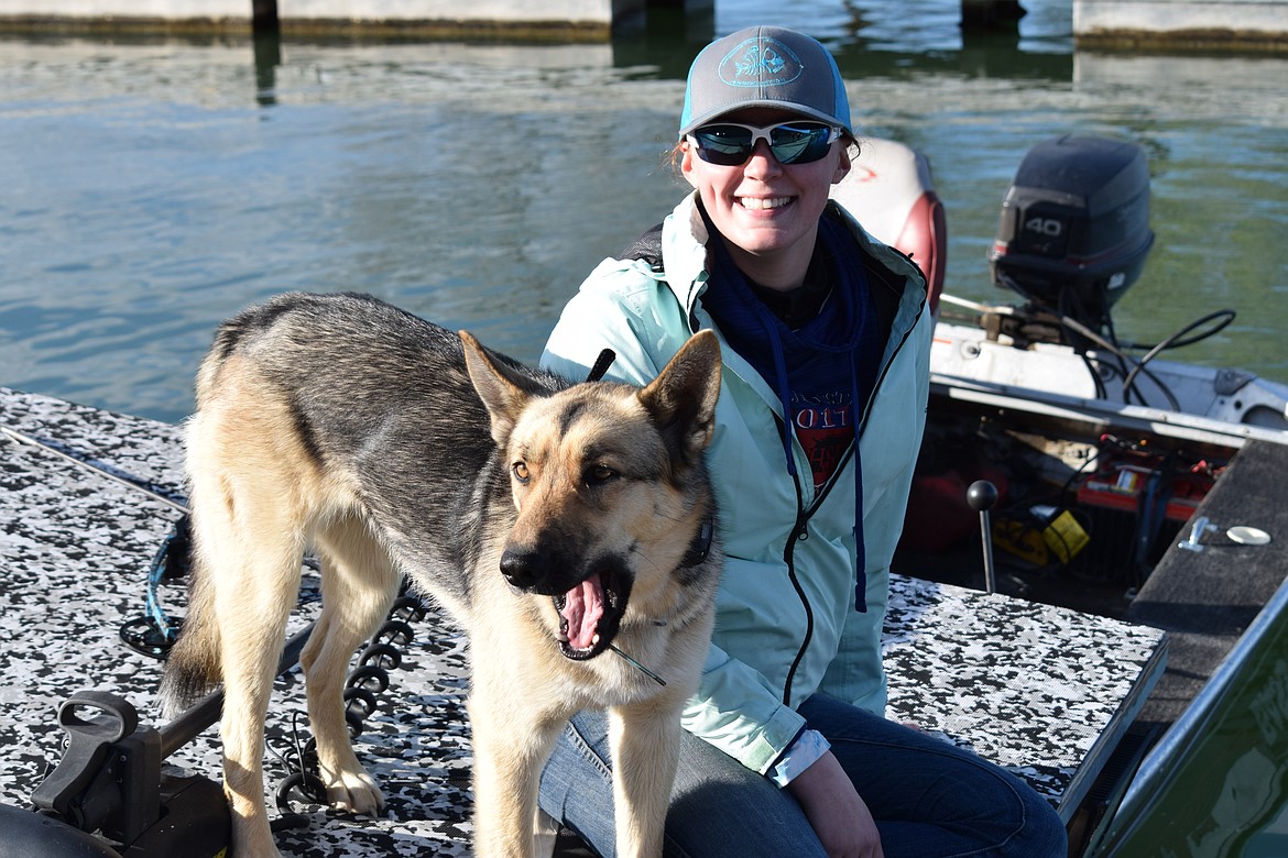 Ephrata native and avid carp shooter Sidnee Pixlee waits on her boat with her dog Nala prior to the start of the Moses Lake Carp Classic on Saturday.