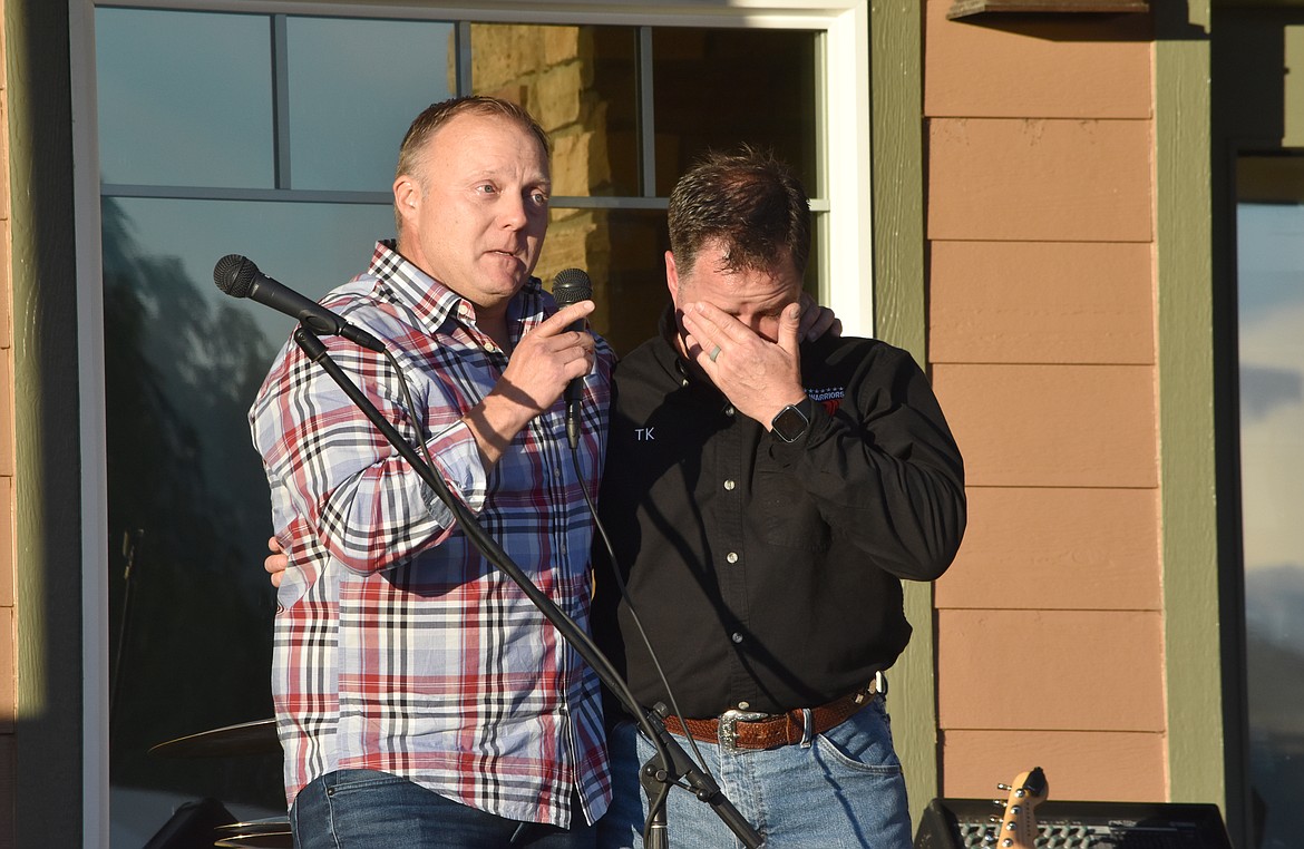 Gerry Fierling, a volunteer with Wake For Warriors, puts his arm around Wake For Warriors PNW chapter coordinator Terry Knight as he got emotional when they spoke to fundraiser attendees on Saturday.