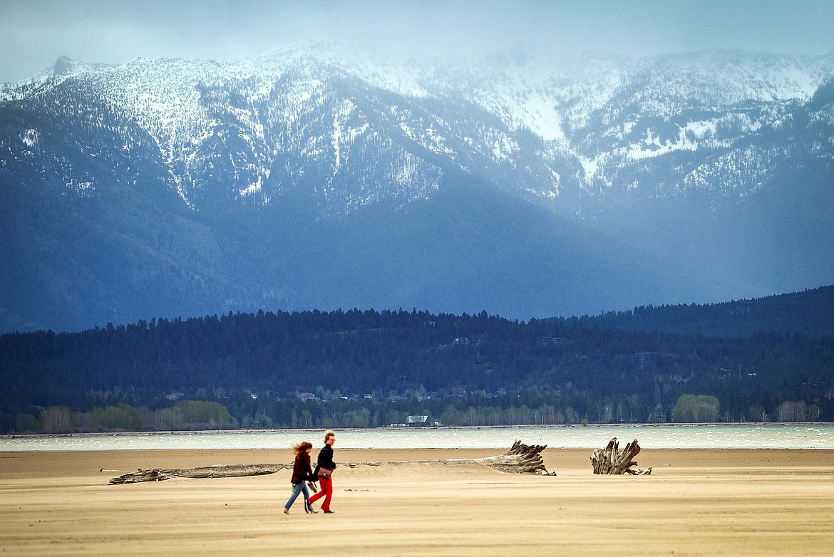 A couple goes for a walk along the beach at Somers Beach State Park on Wednesday, May 18. (Casey Kreider/Daily Inter Lake)