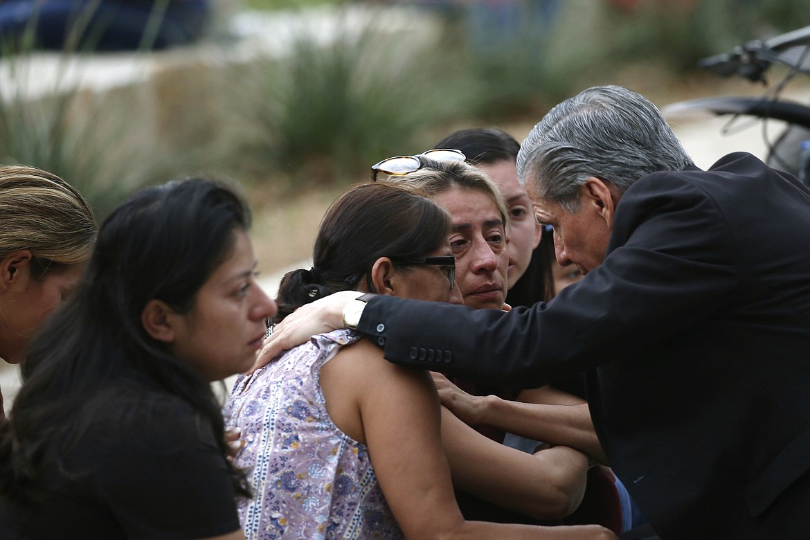 The archbishop of San Antonio, Gustavo Garcia-Siller, comforts families outside the Civic Center following a deadly school shooting at Robb Elementary School in Uvalde, Texas, Tuesday, May 24, 2022. (AP Photo/Dario Lopez-Mills)