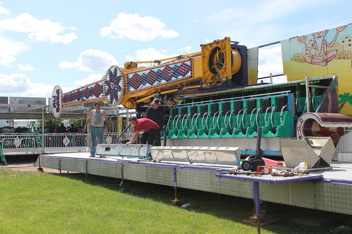 Rainier Amusement workers set up a carnival ride at Lions Field for the Moses Lake Spring Festival Wednesday. The event, which has been on hiatus for two years, returns today.