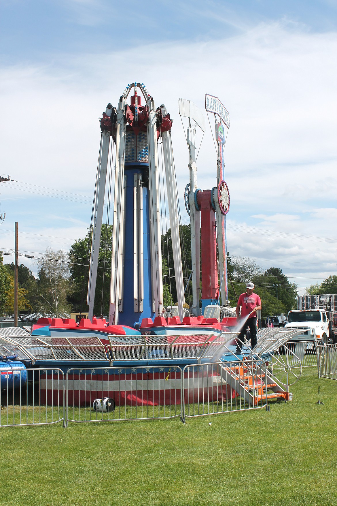A Rainier Amusement worker washes a carnival ride at Lions Field for the Moses Lake Spring Festival Wednesday. The event, which has been on hiatus for two years, returns today.