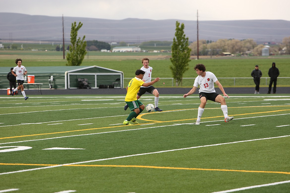 Quincy’s Jorge Nunez pushes the ball upfield past defenders. Nunez was named as player of the year in boys soccer by the Caribou Trail League.