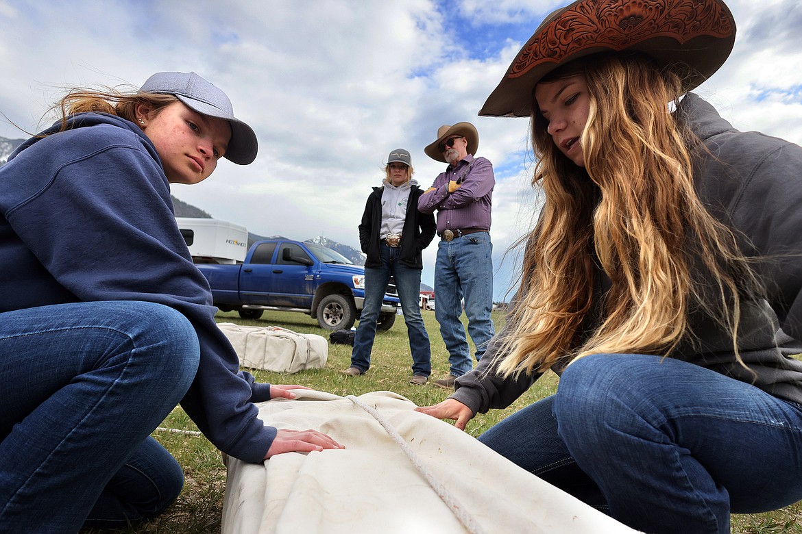 Kimber (left) and Hannah Boll demonstrate their horse packing skills while Rick Mathies and Brady Boll look on. (Jeremy Weber/Daily Inter Lake)