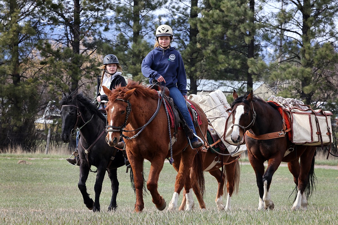 Kimber (center) and Brady Boll lead their pack string near Columbia Falls, showing off their horse packing skills. (Jeremy Weber/Daily Inter Lake)