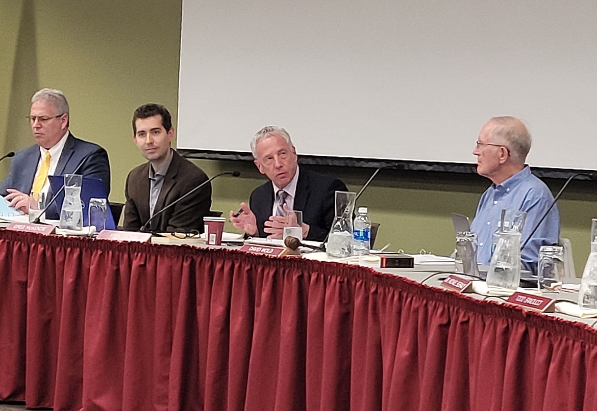 North Idaho College attorney Marc Lyons, center, gestures as he discusses forgone taxes during the board of trustees meeting Wednesday evening.