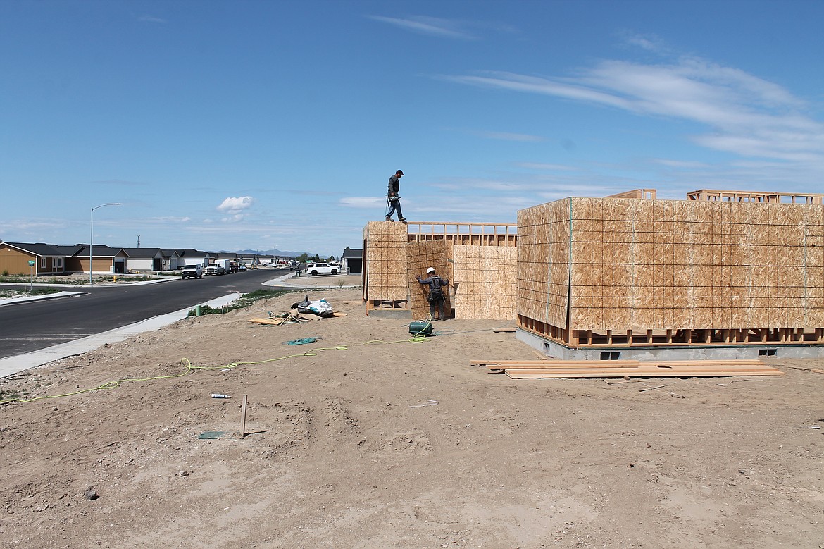 Builders work on a Palos Verdes home in the Sandhill Estates development in Othello. Real estate broker Jessie Dominguez says the homes are “flying off the shelf.”