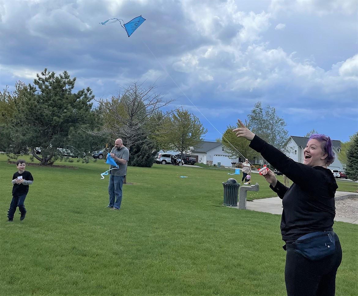 Photo courtesy city of Hayden
Nina Ford flies her kite while son Sully watches and husband Eric untangles his kite.