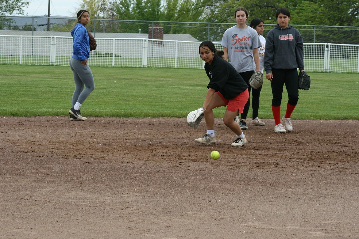 Sophomore Persayis Garza tracks the ball during fielding practice. The Othello High School softball team is the top seed going into the state tournament.