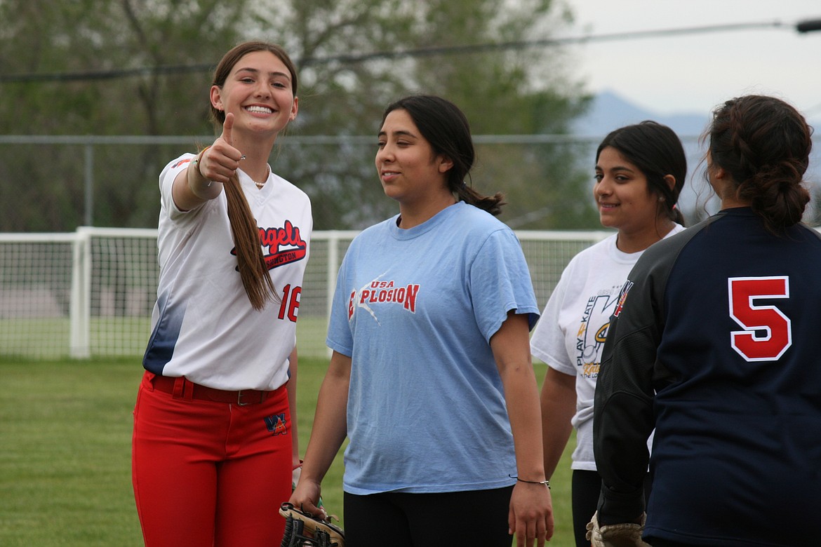 Camryn McDonald  (left) flashes a smile during Othello High School fastpitch softball practice Thursday.