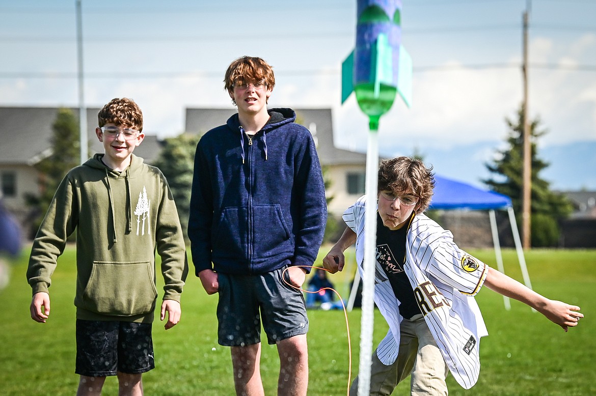 From left, West Valley eighth-graders Caden Foster, Zach Timis and Falon Clark launch their water-powered rocket at the 6th annual Flathead Valley Rocket Rally at Glacier High School on Thursday, May 26. Students first learn the physics of flight and rocket science, then work in teams using the engineering process to design, build, test, analyze and modify their water bottle rockets. (Casey Kreider/Daily Inter Lake)