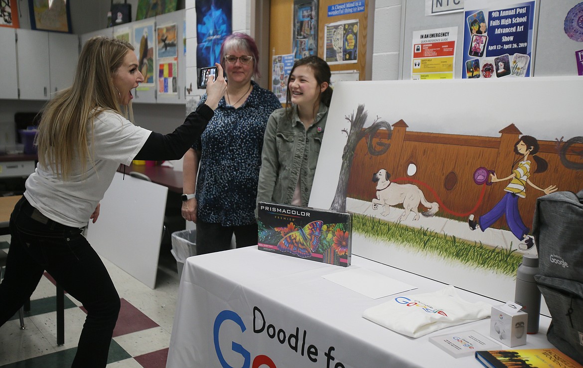 Google brand ambassador Aubreyana Anderson snaps a photo of Idaho state Doodle for Google champ Kaylin O'Halloran with her winning artwork, "It's the Little Things," and art teacher Michelle Chmielewski on Thursday morning.