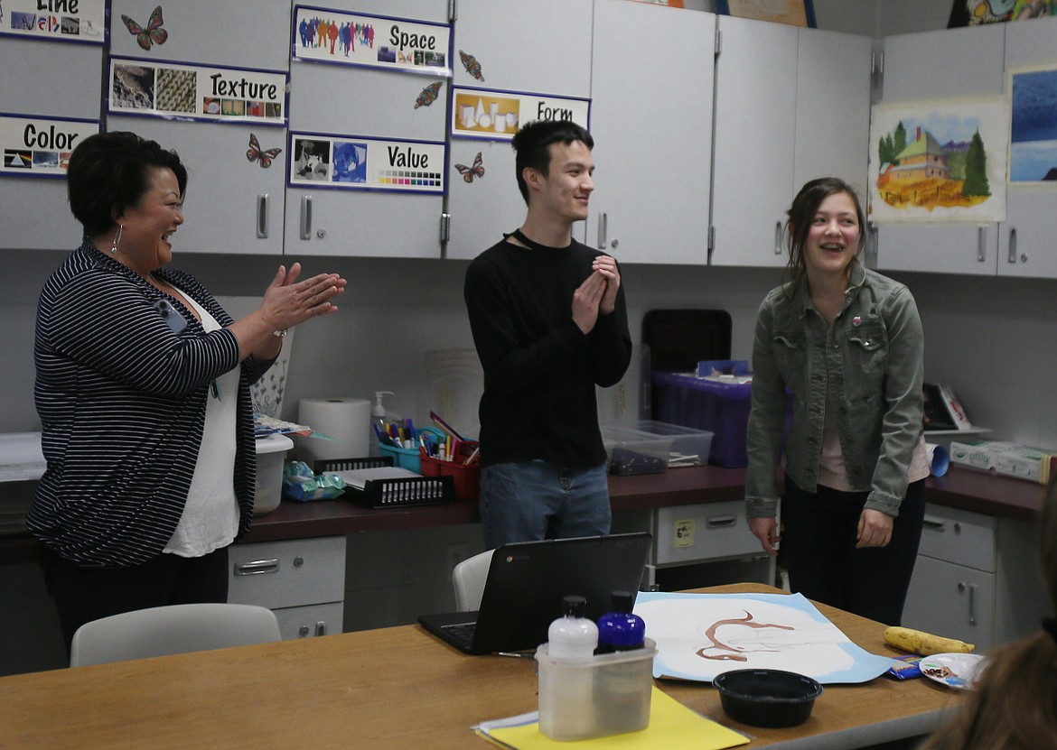 Kaylin O'Halloran, right, reacts as mom Mandy and brother Keagan applaud the announcement that she is the Idaho winner of the Doodle for Google Student Contest. They're pictured in her Post Falls High School art class Thursday morning.
