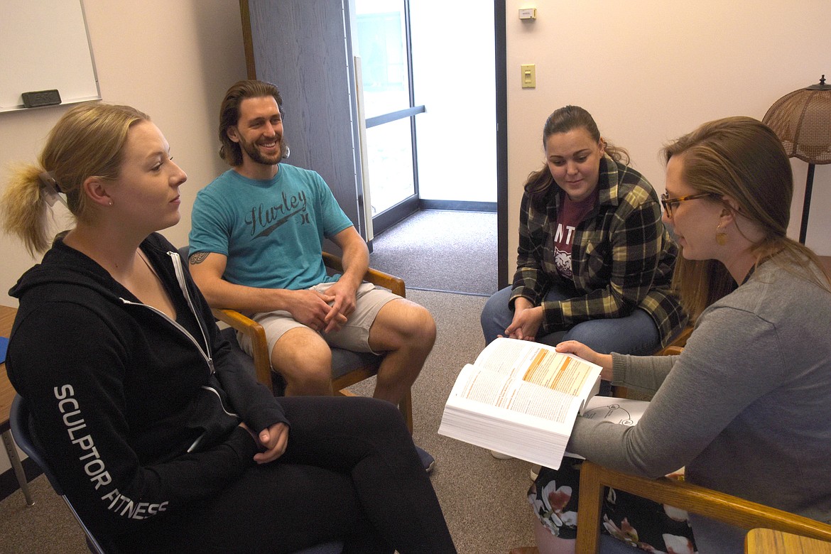 Assistant Professor Olivia Holter, right, meets with school psychology graduate students Courtney Deveny, left, Mason Berndt and Kali Davis in the CWU Psychology Building.