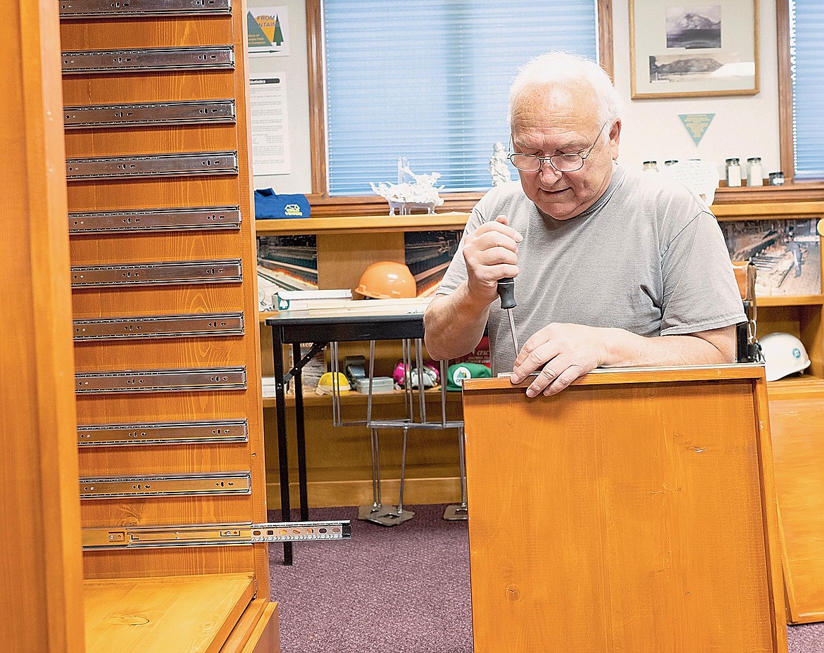 George Lippy works on a cabinet for the new Columbia Falls History Museum.