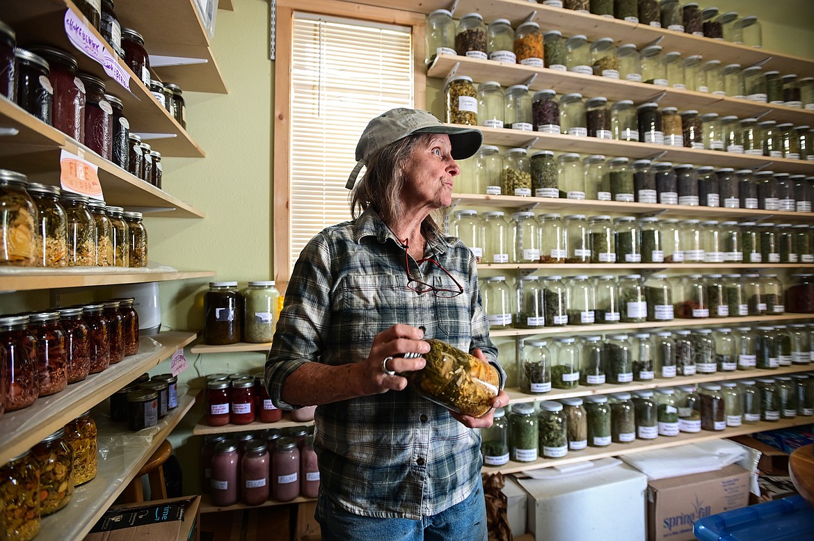 Lindy Dewey talks about the different types of fire cider inside the apothecary at SpiritWorks Trilogy near Whitefish on Thursday, May 26. (Casey Kreider/Daily Inter Lake)