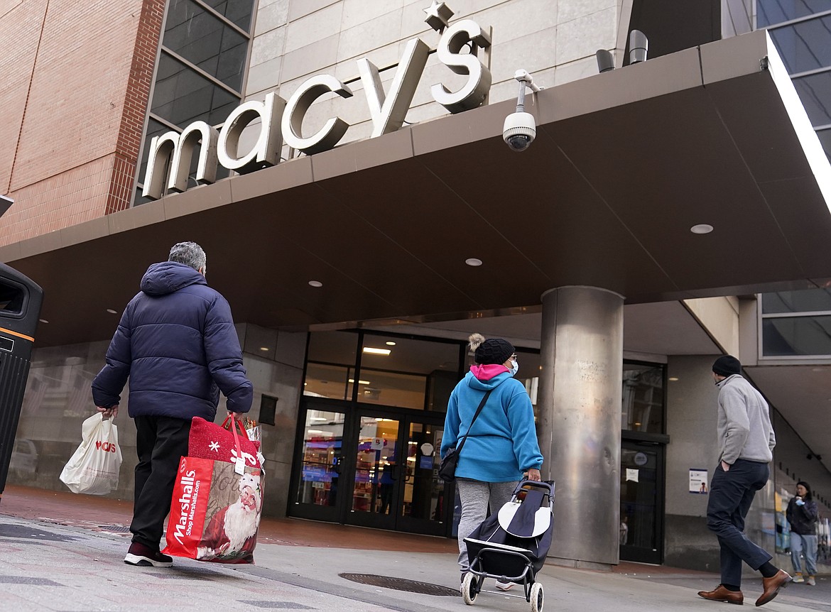 Shoppers walk to the Macy's store in the Downtown Crossing district, Wednesday, Nov. 17, 2021, in Boston. Macy’s reported better-than-expected results for the fiscal first quarter, Thursday, May 26, 2022, even as the department store chain faces higher costs. (AP Photo/Charles Krupa)