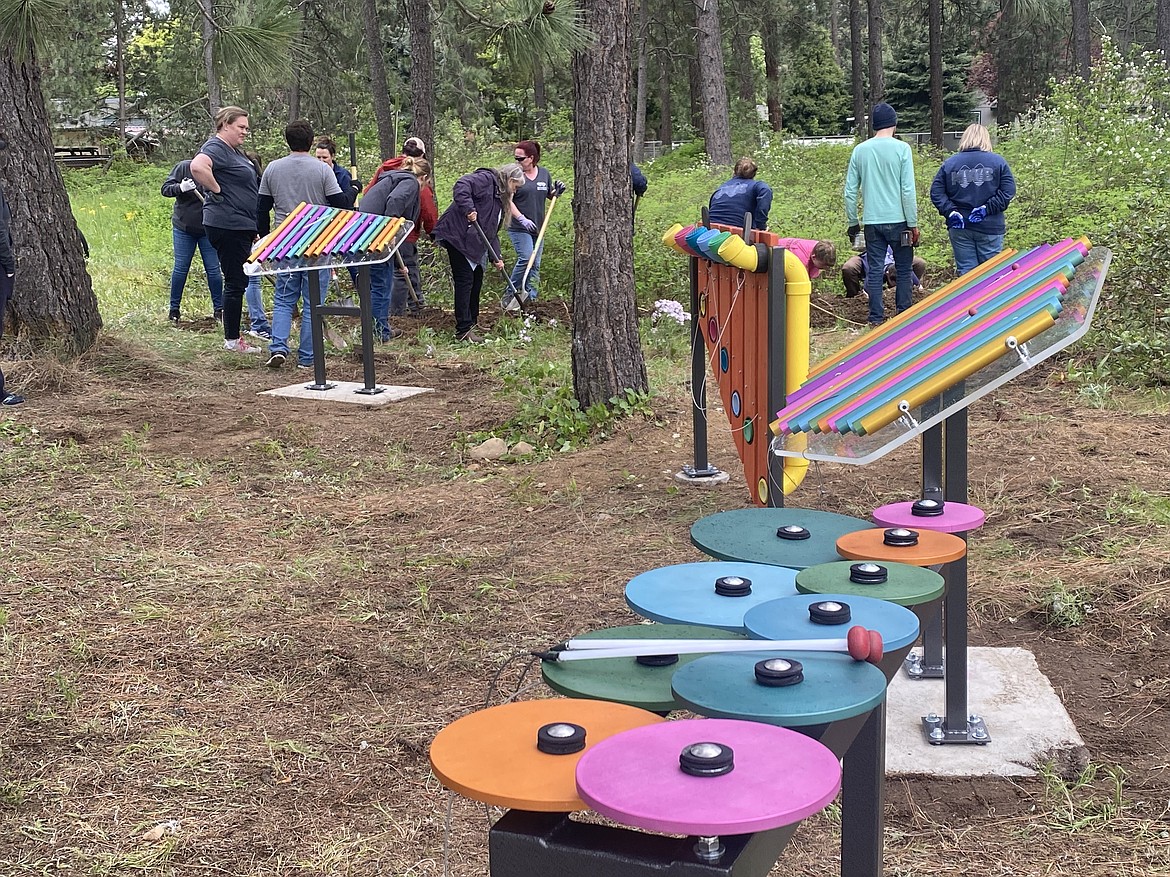 About thirty volunteers from Gizmo-CdA, Mountain West Bank and the Coeur d'Alene Rotary Club helped install the Children's Village musical sensory pod Friday afternoon.