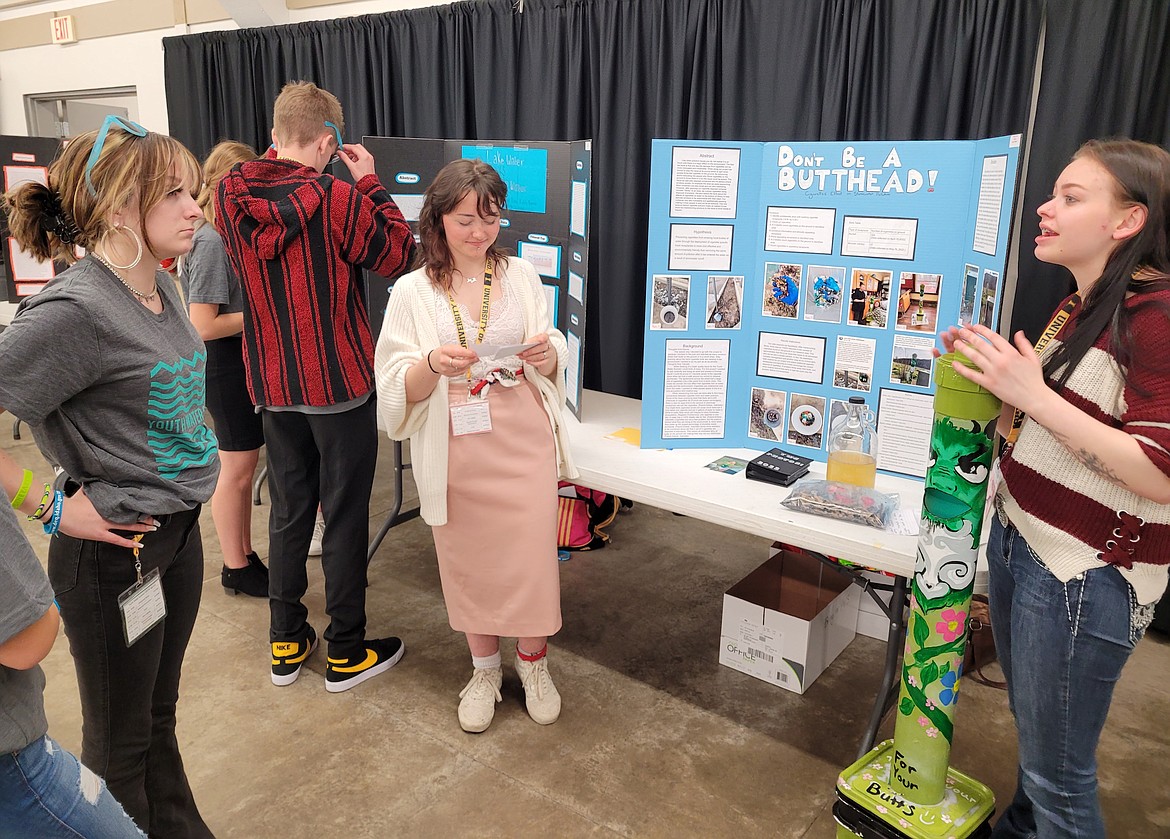 Keona Studt, right, and Tallulah Stafford, center, of Lake Pend Oreille High School, share their cigarette pollution project, "Don't Be a Butthead," during the Youth Water Summit on Wednesday.