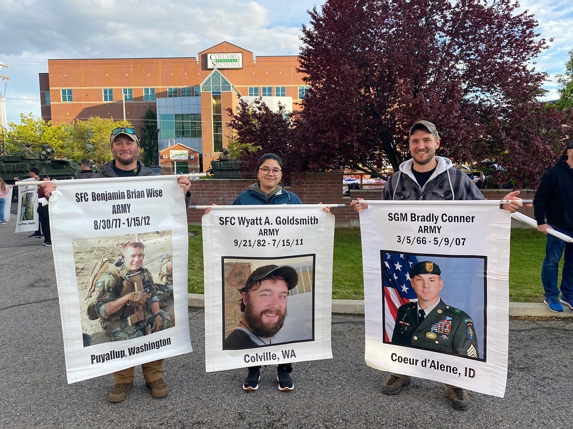 At the Lilac Day Parade, Saturday, May 14, from left: Special Forces Association Chapter 43 External Communications Director, Master Sergeant Nathan Ellison, Taylor Fernandez, and Chapter Treasurer Sergeant First Class Harrison McLean. McLean is currently a reservist with the 19th Special Forces Group. Each is holding a poster commemorating fallen soldiers from the Pacific Northwest.