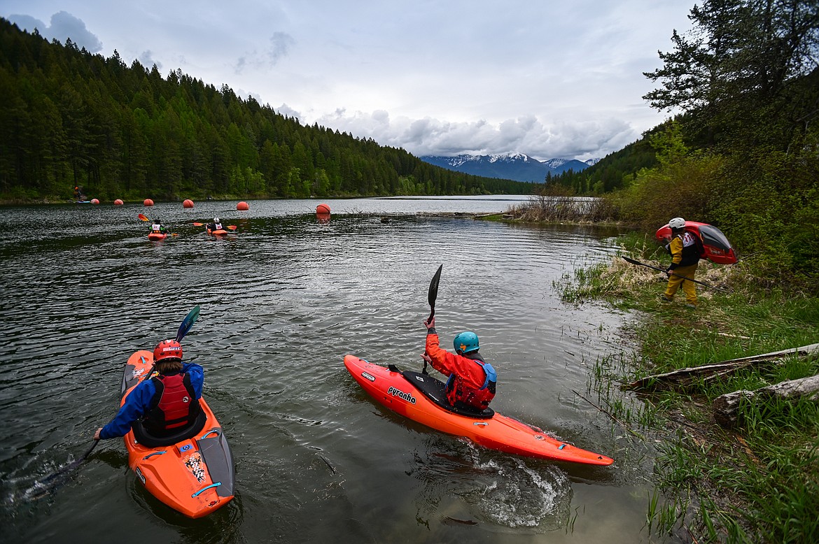 Kayakers paddle around the reservoir before the start of the Expert Slalom at the Bigfork Whitewater Festival on Saturday, May 28. (Casey Kreider/Daily Inter Lake)