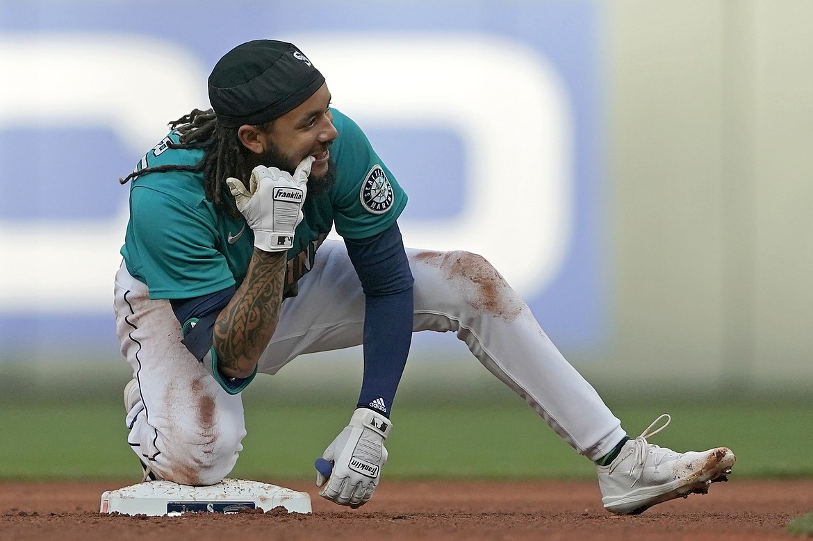 Seattle Mariners' J.P. Crawford reacts at second base after he hit a double against the Houston Astros during the third inning of a baseball game Friday, May 27, 2022, in Seattle.