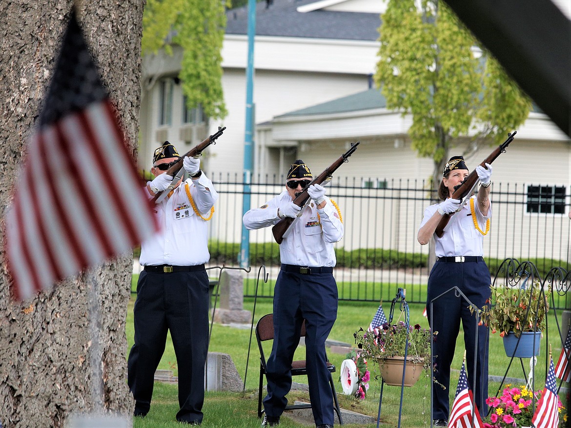 The Color Guard performs a 21-gun salute on Sunday at St. Thomas Cemetery.