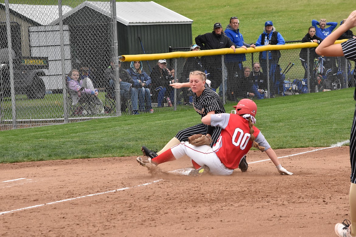 Third baseman Lily De La Rosa tags out a Castle Rock player who slid into her during the state matchup.