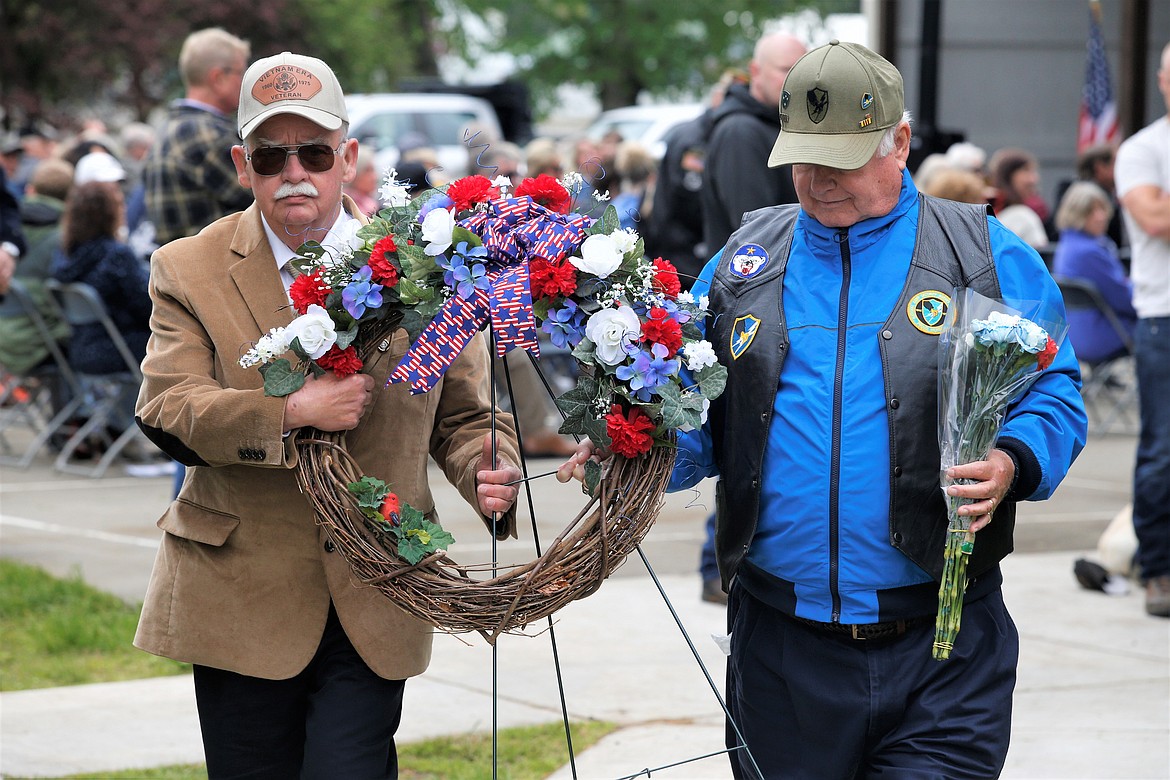 Kenneth Smitheman, right, and Daniel Neese of the Hayden Veterans Commission carry the memorial wreath to the PFC Robert J. Gordon Veterans Memorial Plaza on Memorial Day.