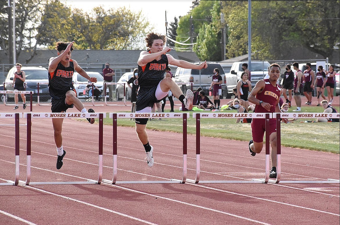 Ephrata junior Travis Hendrick, center, competed at state in the boys 4x100 relay team. Above, he competes in the hurdles earlier this season at an event held in Moses Lake.