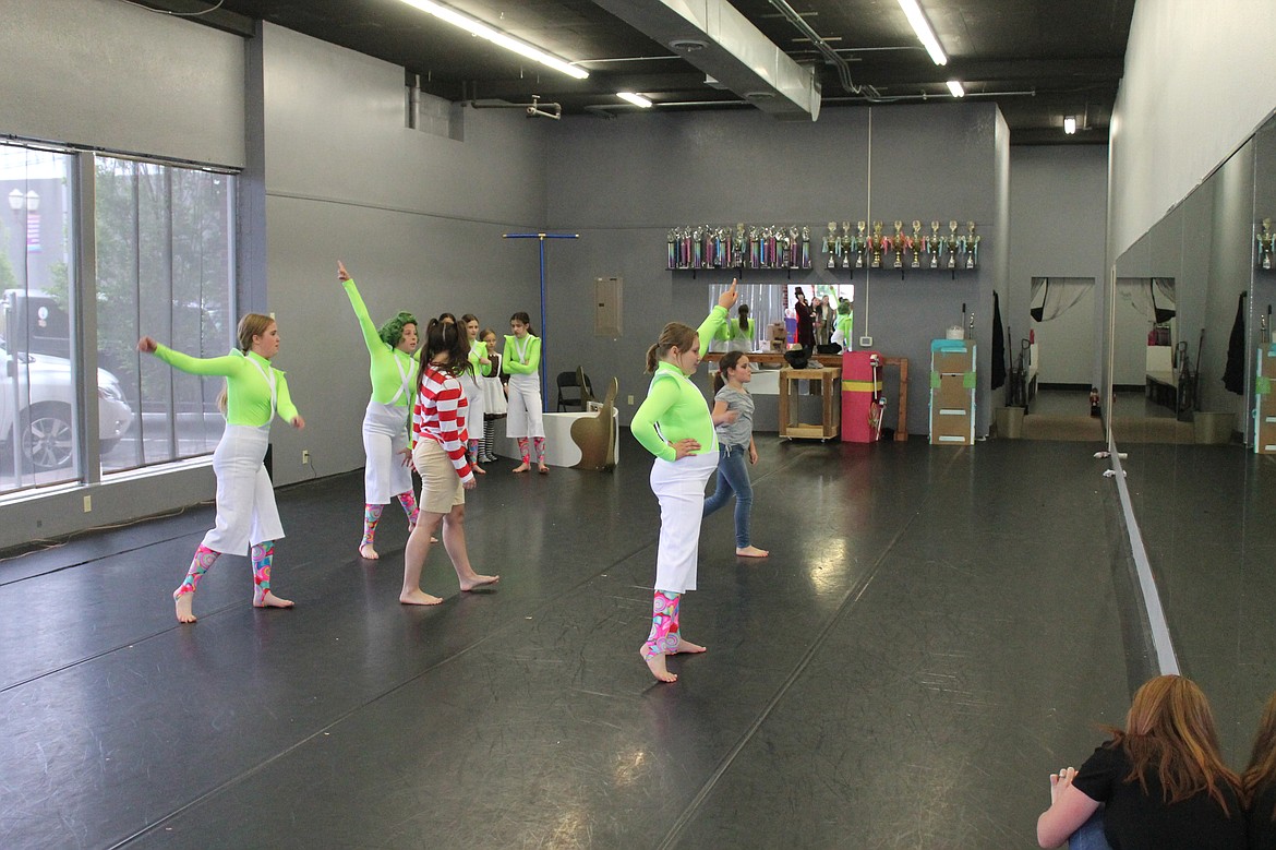Emma Fulkerson (in stripes) as Augustus Gloop and a crowd of Oompa Loompas rehearse for “Willy Wonka” Friday afternoon. The Ballet Academy of Moses Lake will be presenting the show Wednesday and Thursday.